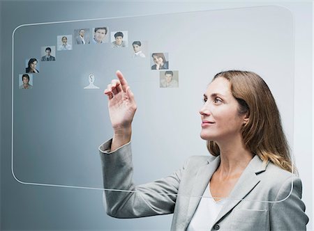 Human resources manager assessing candidates on advanced touch screen interface Stock Photo - Premium Royalty-Free, Code: 632-06317256