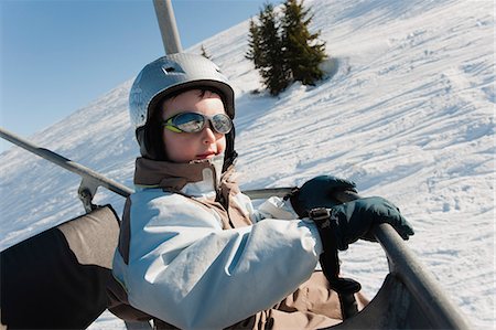 skiers and chairs lifts in snow - Boy riding ski lift at ski resort Stock Photo - Premium Royalty-Free, Code: 632-06317292