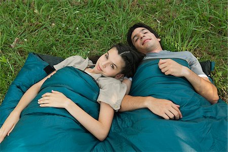 Young couple sharing sleeping bag in field Stock Photo - Premium Royalty-Free, Code: 632-06317307