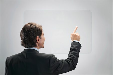 Businessman using large transparent touch screen Foto de stock - Sin royalties Premium, Código: 632-06317353