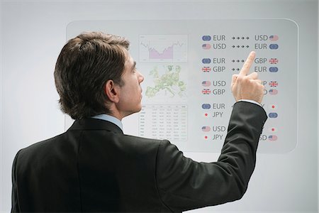 person touch screen - Businessman using advanced touch screen technology to view business data Stock Photo - Premium Royalty-Free, Code: 632-06317397