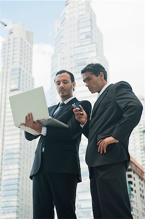 executive and standing and outdoors male - Business executives using laptop computer outdoors Stock Photo - Premium Royalty-Free, Code: 632-06317399