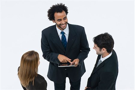 Business associates chatting while colleague uses digital tablet Foto de stock - Sin royalties Premium, Código: 632-06317412