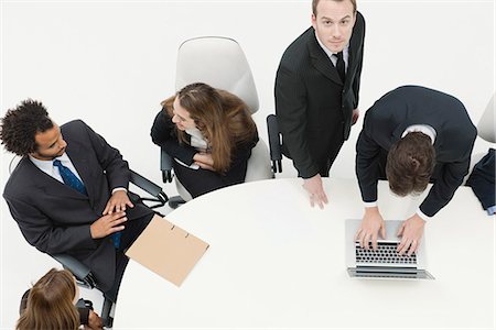 Businessman working with associates at meeting Stock Photo - Premium Royalty-Free, Code: 632-06317461