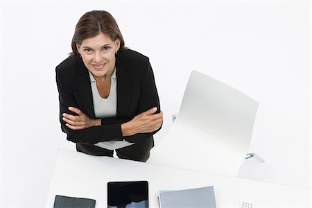 desk directly above - Businesswoman standing by desk with arms folded Stock Photo - Premium Royalty-Free, Code: 632-06317484