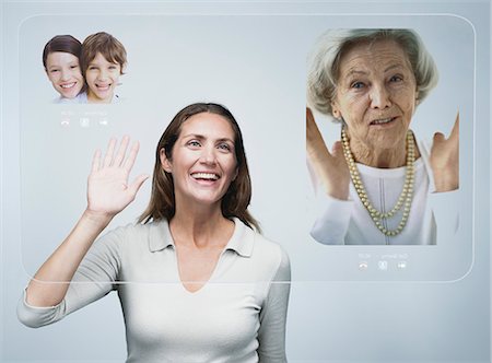 Woman doing video conference with family using advanced screen technology Stock Photo - Premium Royalty-Free, Code: 632-06317491