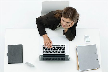 elevated view women sitting - Businesswoman daydreaming at desk Stock Photo - Premium Royalty-Free, Code: 632-06317505