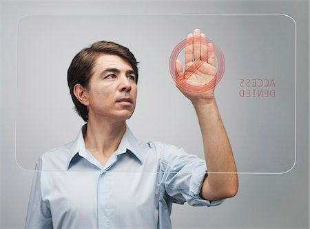 Man denied access on advanced touch screen interface Stock Photo - Premium Royalty-Free, Code: 632-06317525