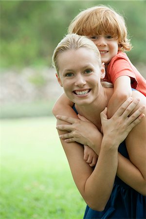 piggyback on mom - Mother carrying son on back, portrait Stock Photo - Premium Royalty-Free, Code: 632-06317547