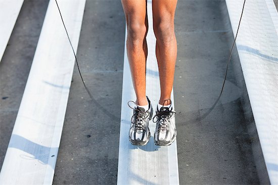 Man jumping rope on bleacher, low section Stock Photo - Premium Royalty-Free, Image code: 632-06317605