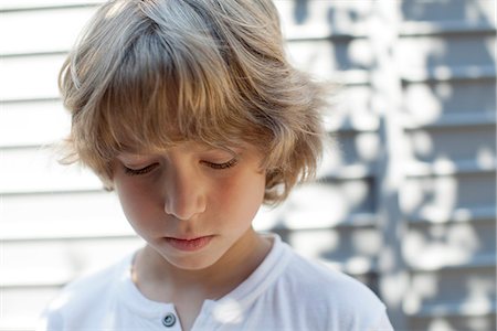 Boy looking down, portrait Stock Photo - Premium Royalty-Free, Code: 632-06317731