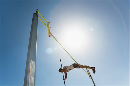 Male athlete jumping over high jump bar Stock Photo - Premium Royalty-Free, Code: 632-06317813