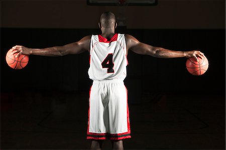 Basketball player holding two basketballs, rear view Stock Photo - Premium Royalty-Free, Code: 632-06317820