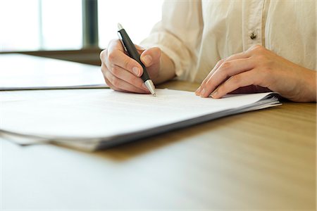 paperwork in hand - Person signing paperwork Stock Photo - Premium Royalty-Free, Code: 632-06317868