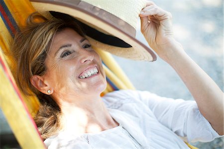 sun hat - Mature woman relaxing in hammock, portrait Stock Photo - Premium Royalty-Free, Code: 632-06317908