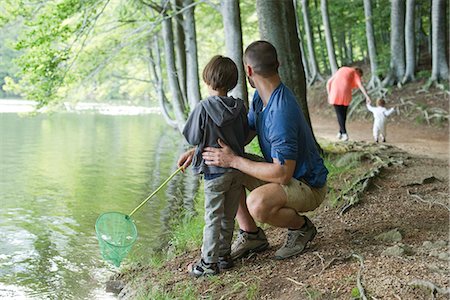 father and son and fishing - Father and son fishing in woods, both looking away Stock Photo - Premium Royalty-Free, Code: 632-06317916