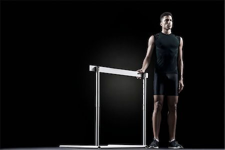 simsearch:632-05817078,k - Male athlete standing by hurdle Stock Photo - Premium Royalty-Free, Code: 632-06317956