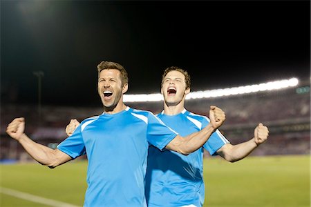 simsearch:632-05603965,k - Soccer players celebrating, portrait Fotografie stock - Premium Royalty-Free, Codice: 632-06318041