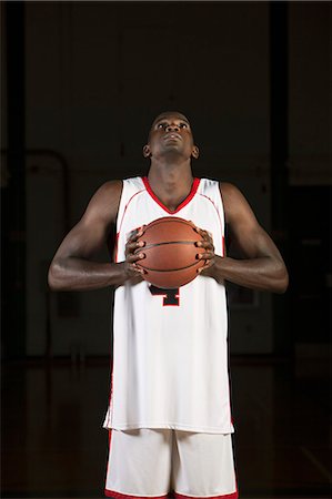 sports basketball portrait black background - Basketball player holding basketball, portrait Stock Photo - Premium Royalty-Free, Code: 632-06318103