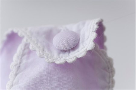 delicate - Close-up of button on baby clothing Stock Photo - Premium Royalty-Free, Code: 632-06354025