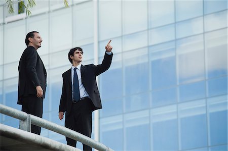 people balcony looking - Business associates standing together outdoors, one pointing Stock Photo - Premium Royalty-Free, Code: 632-06354125