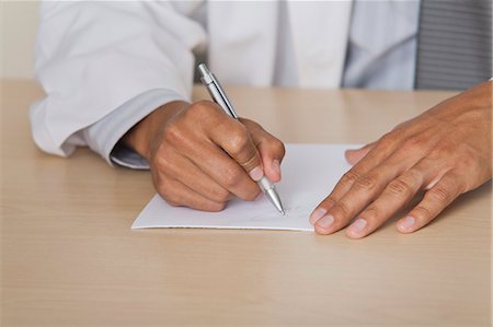 Doctor writing prescription, cropped Stock Photo - Premium Royalty-Free, Code: 632-06354148