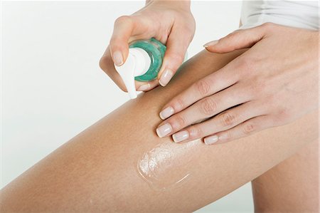 simsearch:632-05844991,k - Woman moisturizing bare leg, cropped Stock Photo - Premium Royalty-Free, Code: 632-06353939
