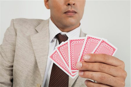 playing card images on hand - Man playing card game, cropped Stock Photo - Premium Royalty-Free, Code: 632-06353990