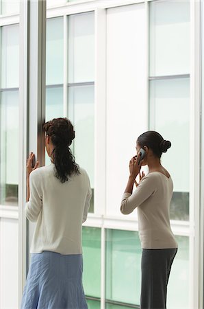 simsearch:614-07652551,k - Office workers standing by window, one woman talking on cell phone, rear view Stock Photo - Premium Royalty-Free, Code: 632-06404283