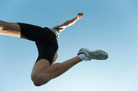 simsearch:633-06322313,k - Man jumping in air, directly below Stock Photo - Premium Royalty-Free, Code: 632-06404293