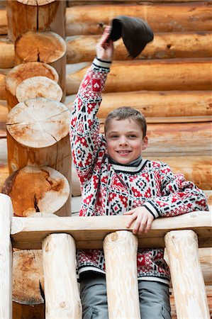 simsearch:632-09021638,k - Boy standing on deck of log cabin, waving hat at camera, portrait Stock Photo - Premium Royalty-Free, Code: 632-06404328