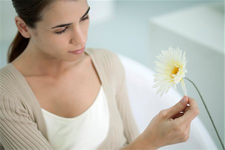 simsearch:632-03847818,k - Young woman plucking petals from gerbera daisy Stock Photo - Premium Royalty-Free, Code: 632-06404357