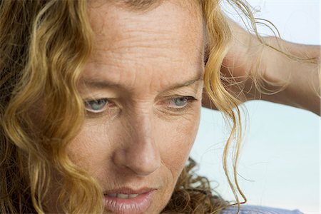 Mature woman looking down in thought Stock Photo - Premium Royalty-Free, Code: 632-06404503