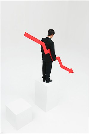 simsearch:632-06317171,k - Businessman standing at top of steps holding arrow pointed downward Stock Photo - Premium Royalty-Free, Code: 632-06404611