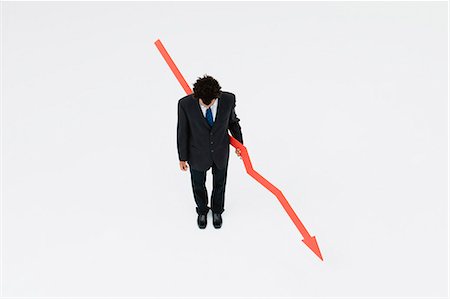 down - Businessman with arrow pointed downward, projecting financial loss Stock Photo - Premium Royalty-Free, Code: 632-06404630