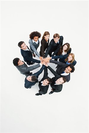 simsearch:632-06404693,k - Business associates standing in circle with hands clasped in motivational exercise Foto de stock - Sin royalties Premium, Código: 632-06404631