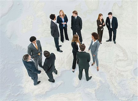 Executives chatting while standing on map of Europe Stock Photo - Premium Royalty-Free, Code: 632-06404693