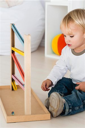 Baby playing with marble rolling game Stock Photo - Premium Royalty-Free, Code: 632-06779167