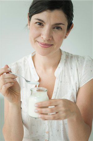 Woman eating yogurt, portrait Stock Photo - Premium Royalty-Free, Code: 632-06779168