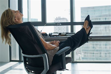 récliner - Businesswoman leaning back in chair with feet up on desk Photographie de stock - Premium Libres de Droits, Code: 632-06779309