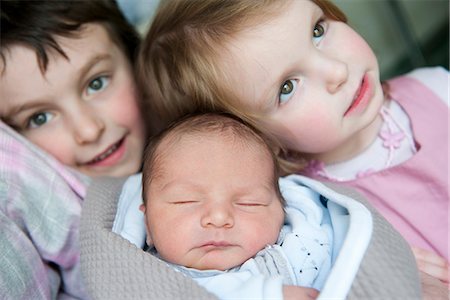 sibling newborn - Boy and girl with baby brother Stock Photo - Premium Royalty-Free, Code: 632-06779353