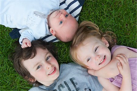 elementary age 2012 - Young siblings lying on grass, portrait Stock Photo - Premium Royalty-Free, Code: 632-06967568