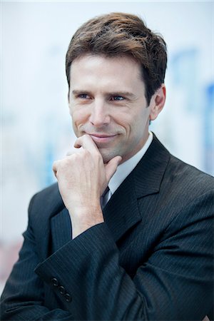 portrait 30s man not woman - Businessman smiling and looking away in thought, portrait Stock Photo - Premium Royalty-Free, Code: 632-06967579