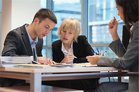 executive at desk - Business people reviewing contract while meeting with female excutive Stock Photo - Premium Royalty-Free, Code: 632-06967648