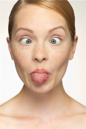 simsearch:632-07494958,k - Young woman sticking out tongue Photographie de stock - Premium Libres de Droits, Code: 632-07161261