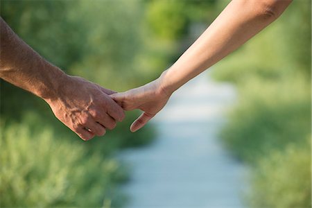 Couple hesitantly hold hands, close-up Stock Photo - Premium Royalty-Free, Code: 632-07161277