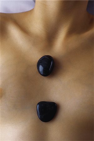 Woman with hot stones on chest, extreme close-up Stock Photo - Premium Royalty-Free, Code: 632-07161337