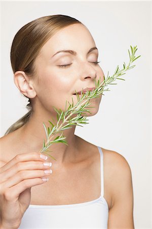females smelling food - Young woman enjoying frangrence of fresh rosemary Stock Photo - Premium Royalty-Free, Code: 632-07161374