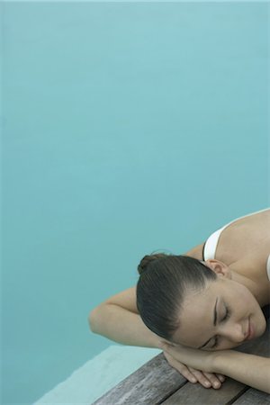 simsearch:695-05763702,k - Woman lying next to pool, resting head on arms, eyes closed Photographie de stock - Premium Libres de Droits, Code: 632-07161521