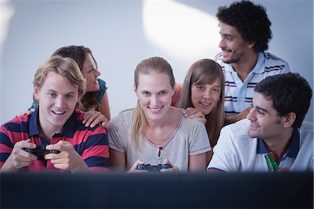 Friends playing video games together Stock Photo - Premium Royalty-Free, Code: 632-07161544
